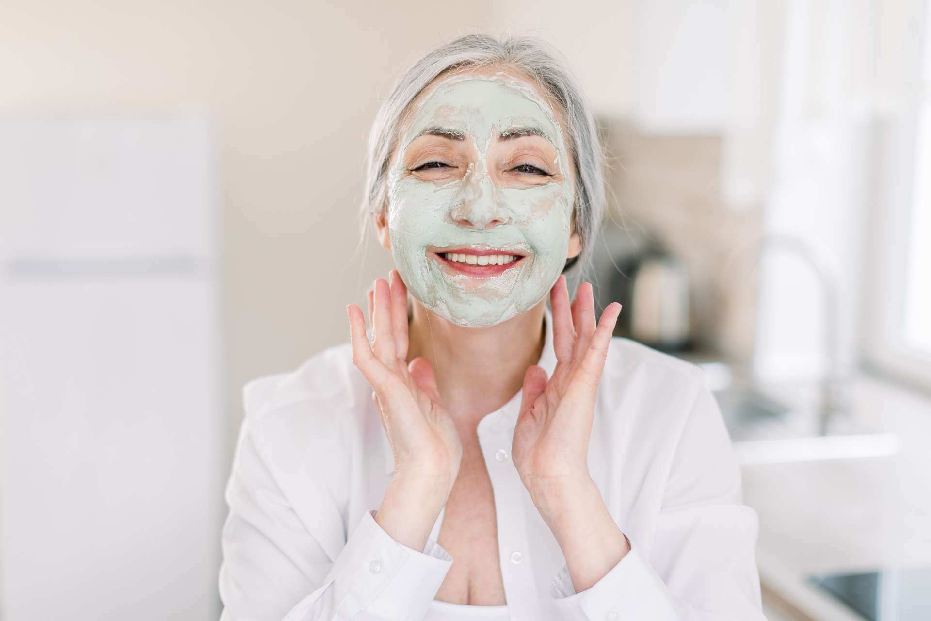 Elderly woman enjoying Anti-Aging Facial Chevy Chase treatment with hydrating mask.
