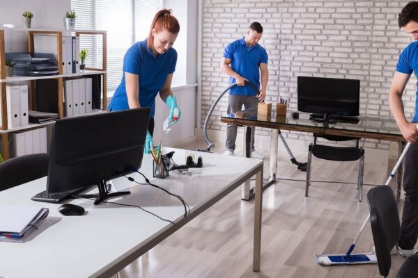 Professional Commercial and Office Cleaning Services in Cary, NC Professional cleaners delivering commercial and office cleaning services in Cary, NC, focusing on windows and desks.